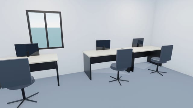 Desks with monitors and task chairs beside a large office window